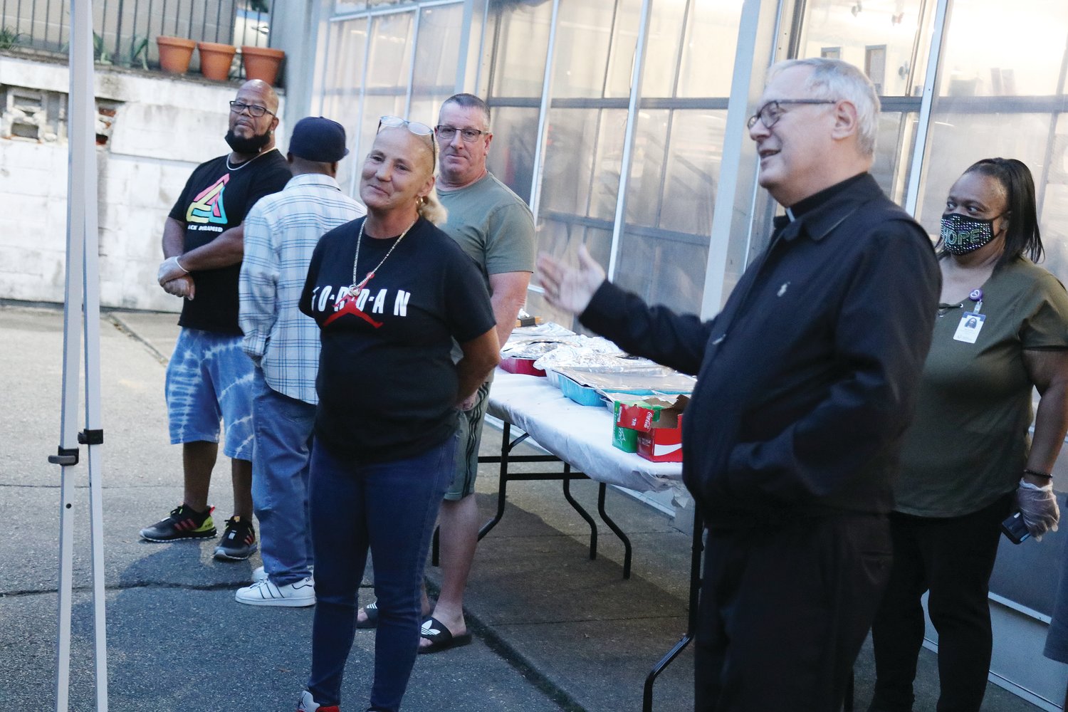 Bishop Thomas J. Tobin announces the 150 Acts of Charity initiative during a cookout to honor Emmanuel House Site Manager Dotty Perrault, and the staff and volunteers who keep the shelter operational.